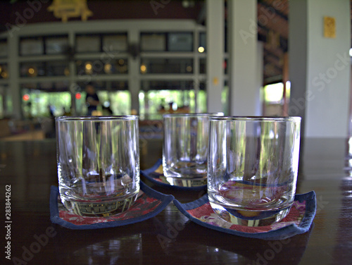The glass is placed on the tray on the table in the restaurant, Selective focus, Blurred.