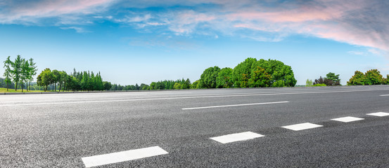Country road and green woods nature landscape in summer