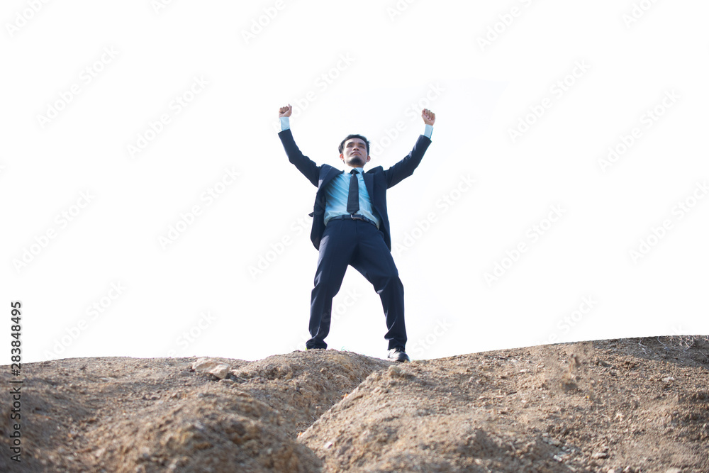Businessman standing on mountain and holding hand success concept Businessman standing on mountain and holding hand success concept