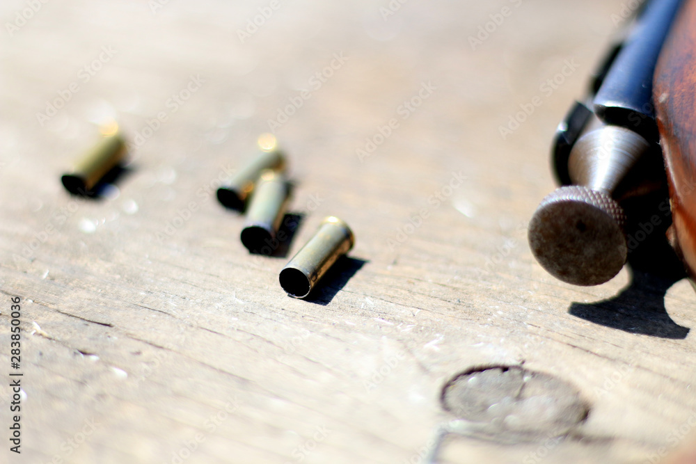 Bullet Casing On Wooden Table Bullet Casing On Wooden Table