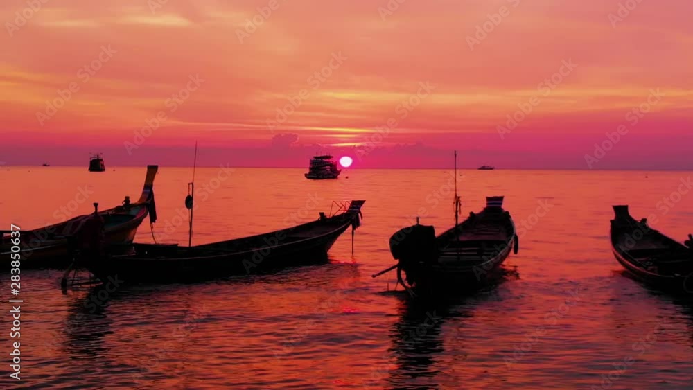 Aerial shot of Koh Tao island, Super sunset at Sairee Beach with many boats floating Thailand Aerial shot of Koh Tao island, Super sunset at Sairee Beach with many boats floating Thailand