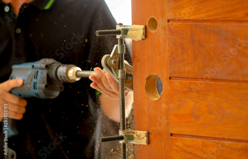 Drilling and installation of new lock on the wooden door