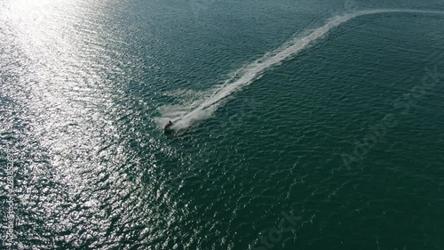 Drone aerial of jet ski flying across the water in the Gulf of Mexico photo