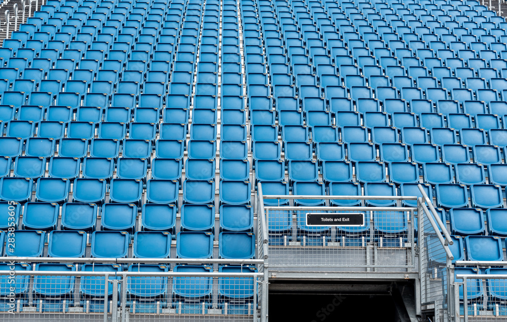 Naklejka premium Blue plastic empty stadium chairs in a row