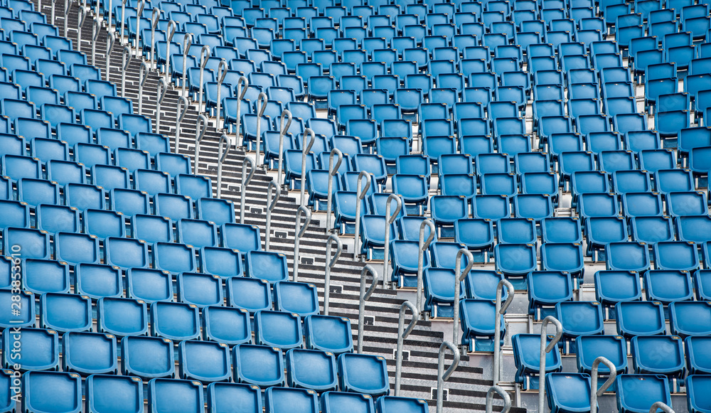 Naklejka premium Blue plastic empty stadium chairs in a row