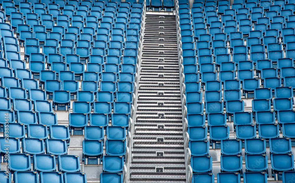 Naklejka premium Blue plastic empty stadium chairs in a row