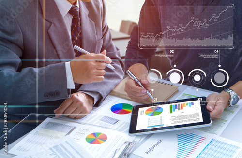 Two businessmen are deeply reviewing financial reports for a return on investment or investment risk analysis and business performance.