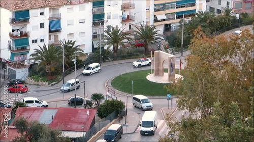 cars in early morning rush hour at roundabout in Andalusian village