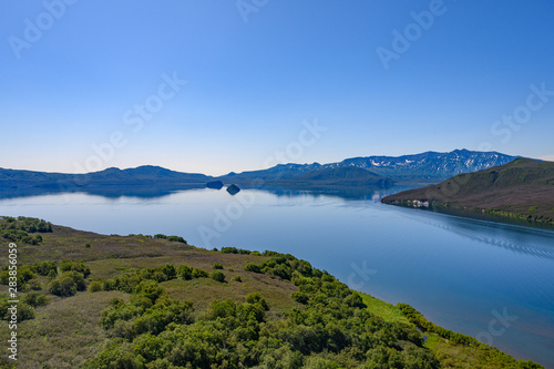 Panoramic view of the city Petropavlovsk-Kamchatsky and volcanoes: Koryaksky Volcano, Avacha Volcano, Kozelsky Volcano. Russian Far East, Kamchatka Peninsula.