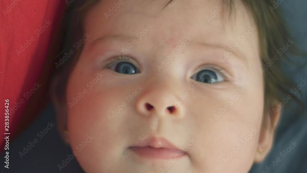 Slow motion of beautiful baby girl looking at the camera Slow motion of beautiful baby girl looking at the camera