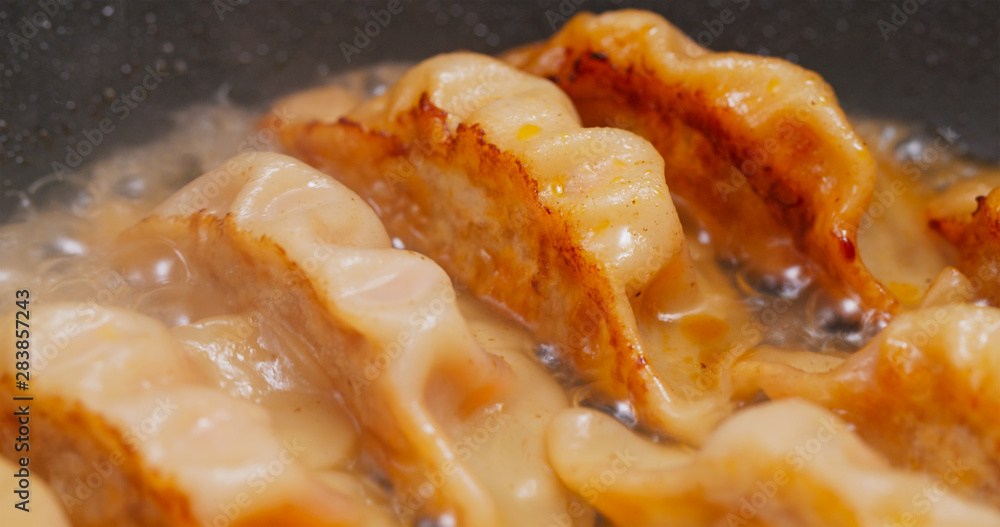 Fry meat dumpling on pan in kitchen Fry meat dumpling on pan in kitchen