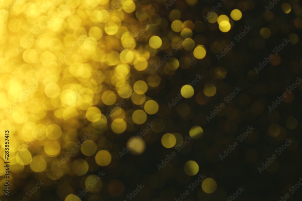 Golden glitter blurred background. Gold on black. Soft focus. Christmas and New Year shining background Golden glitter blurred background. Gold on black. Soft focus. Christmas and New Year shining background