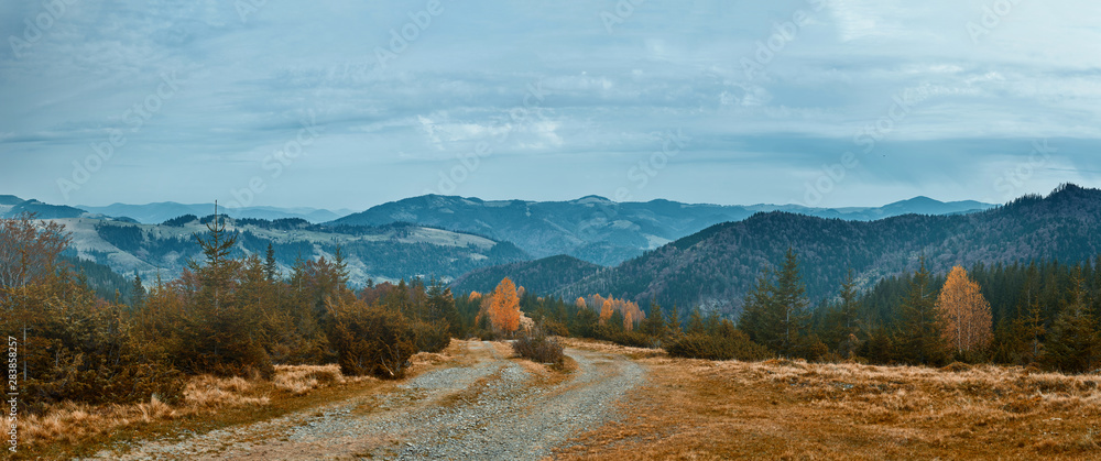 beautiful view of an autumn mountain landscape with a roug mountain road.