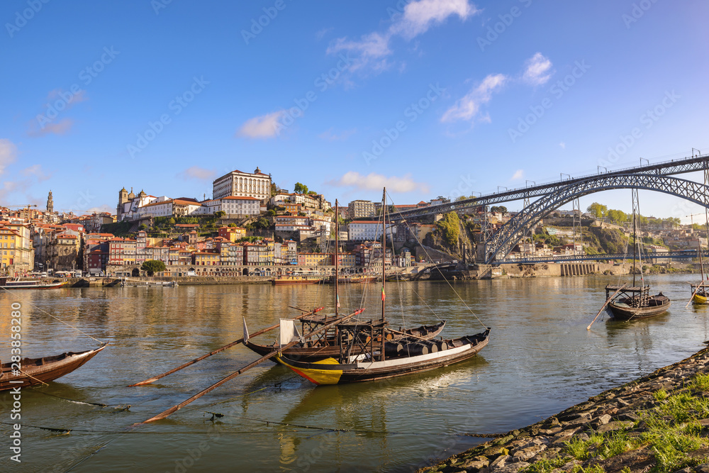 Obraz premium Porto Portugal city skyline at Porto Ribeira and Douro River with Rabelo wine boat and Dom Luis I Bridge