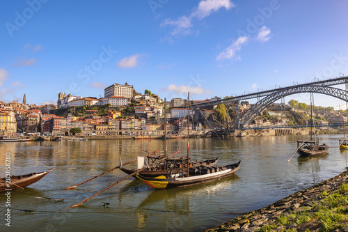 Porto Portugal city skyline at Porto Ribeira and Douro River with Rabelo wine boat and Dom Luis I Bridge