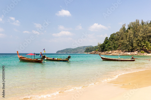 Longtail boats anchored at Banana beach, Phuket, Thailand © Kevin Hellon