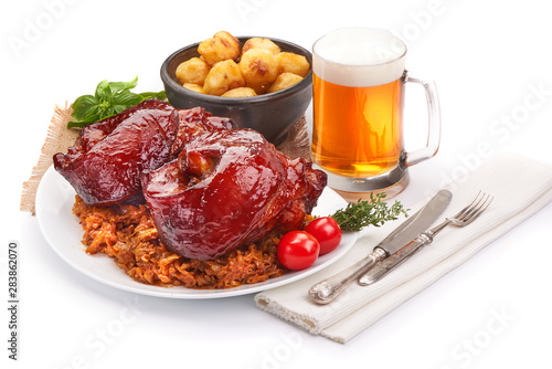 Roasted Pork knuckle with baked potatoes and dark barley beer, oktoberfest dishes, isolated on white background