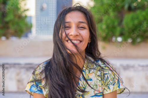 Young indian woman laughing in the street