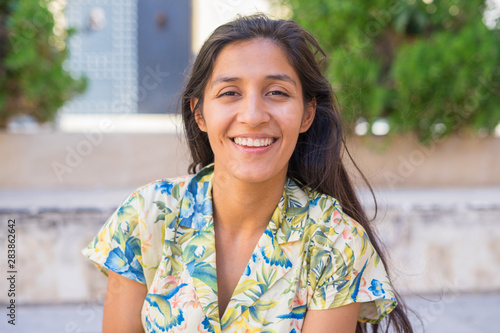 Young indian woman laughing in the street
