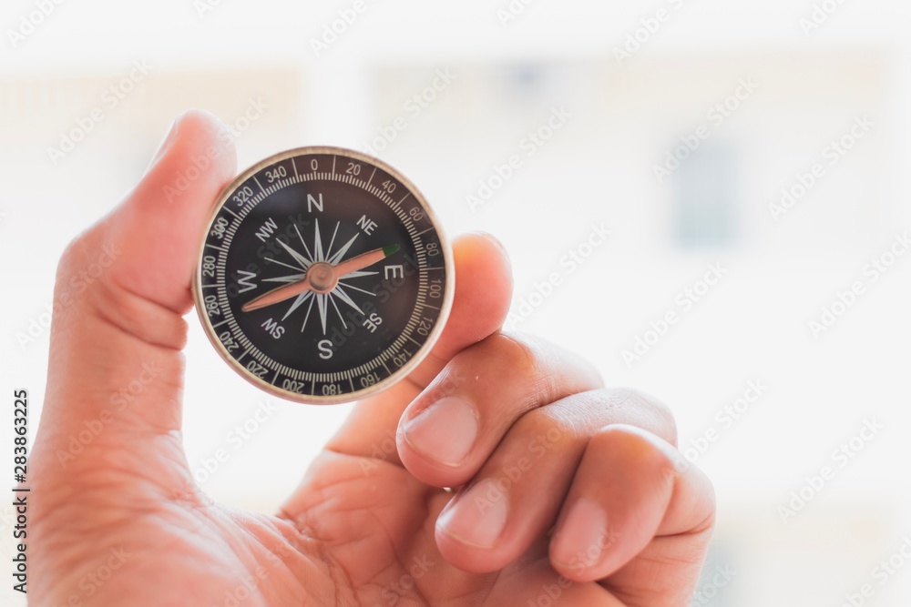 man holding compass on blurred background. for activity lifestyle man holding compass on blurred background. for activity lifestyle