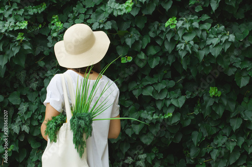 Girl with an eco bag on a juicy green background.