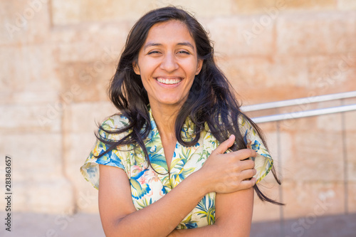 Young indian woman laughing in the street