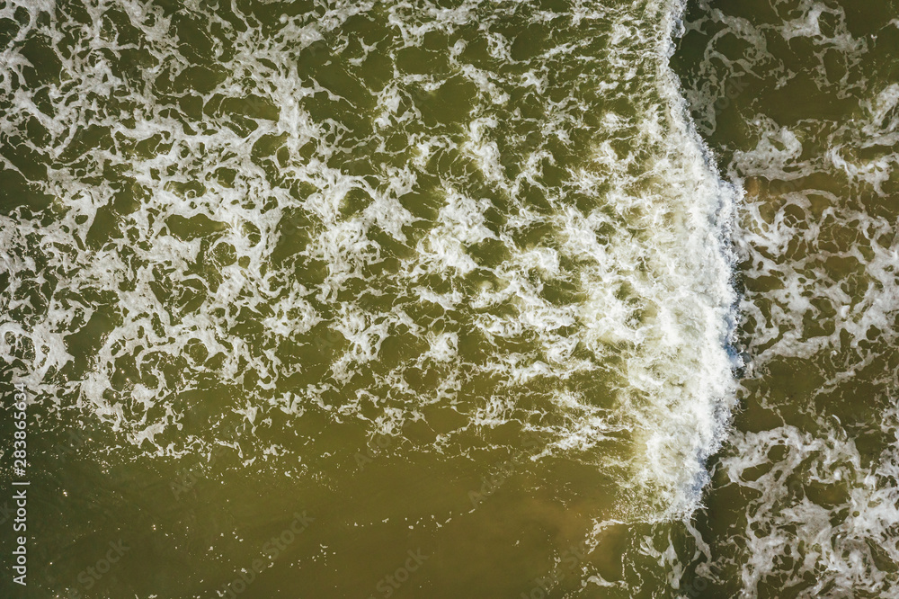 Aerial view of beach, sea waves and sand on baltic coast beach, nature background Aerial view of beach, sea waves and sand on baltic coast beach, nature background