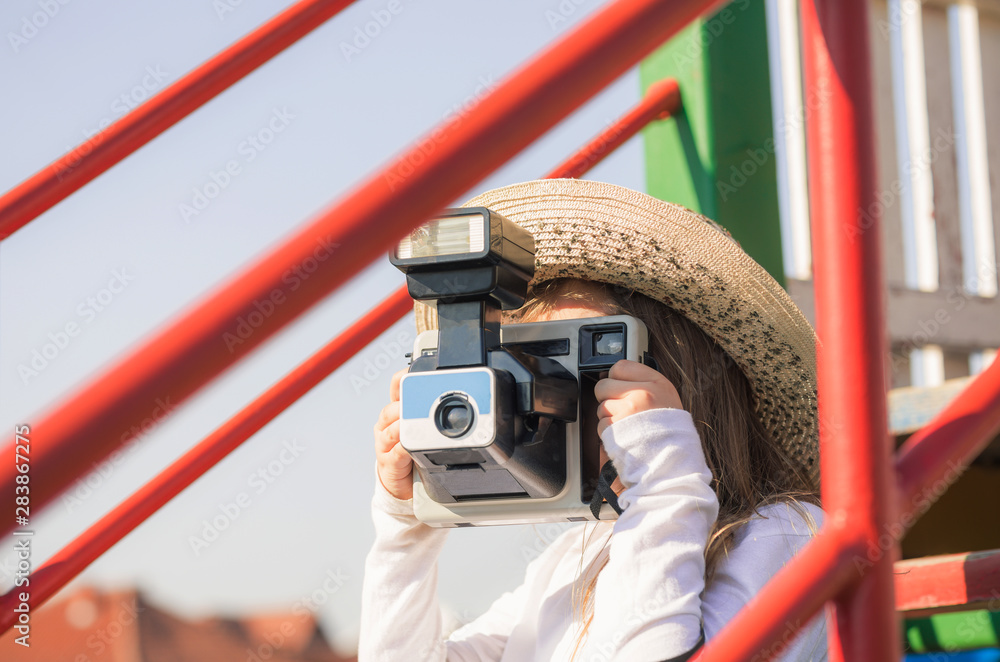 Young girl with old vintage polaroid camera at playground. Young little  hipster girl with hat and camera. Creative kids concept. Stock Photo |  Adobe Stock