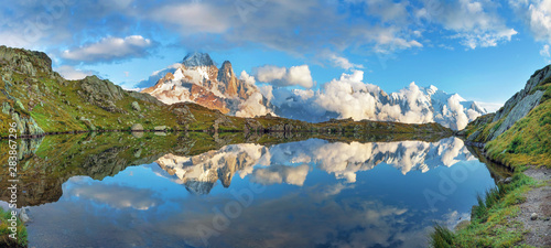 Sunset panorama of the Lac Blanc lake with Mont Blanc (Monte Bianco) on background in Chamonix location. Beautiful outdoor scene in Vallon de Berard Nature Reserve, France