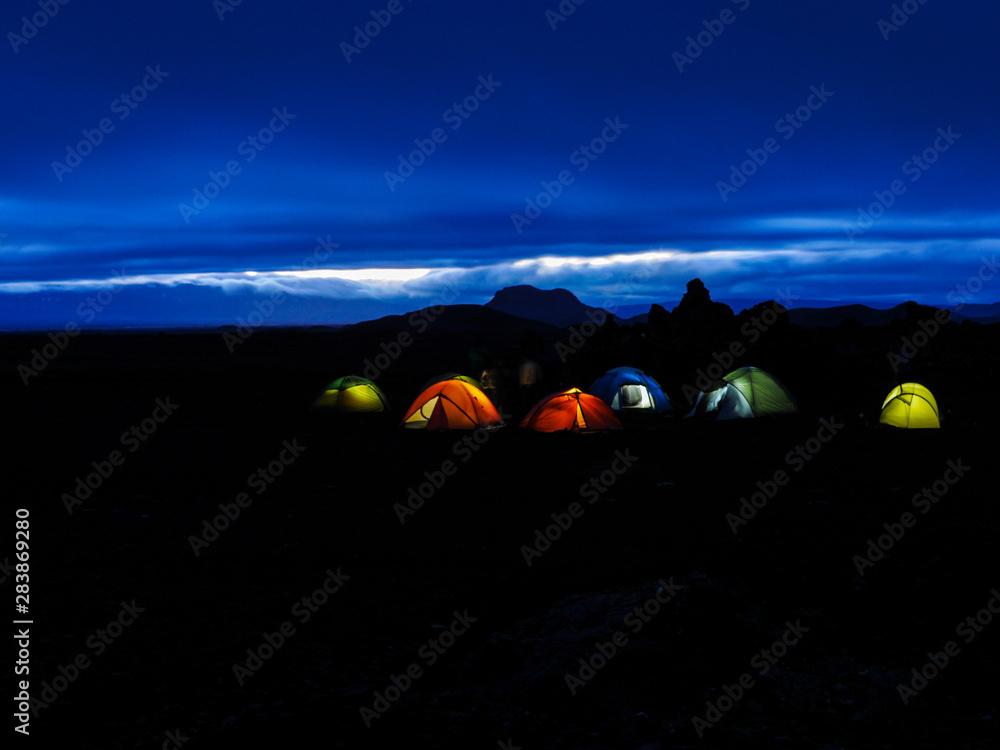 illuminated tents in a summer night in iceland