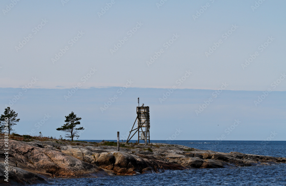 A  seamark standing on a cliff on the islet of the Bothnian sea