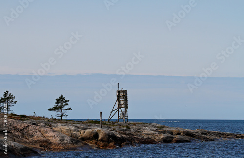 A  seamark standing on a cliff on the islet of the Bothnian sea © puteli