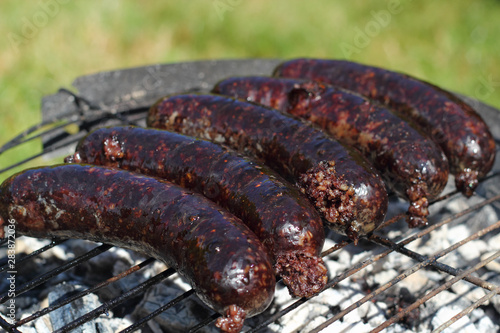 Photography Grilling Blood Sausages on barbecue grill