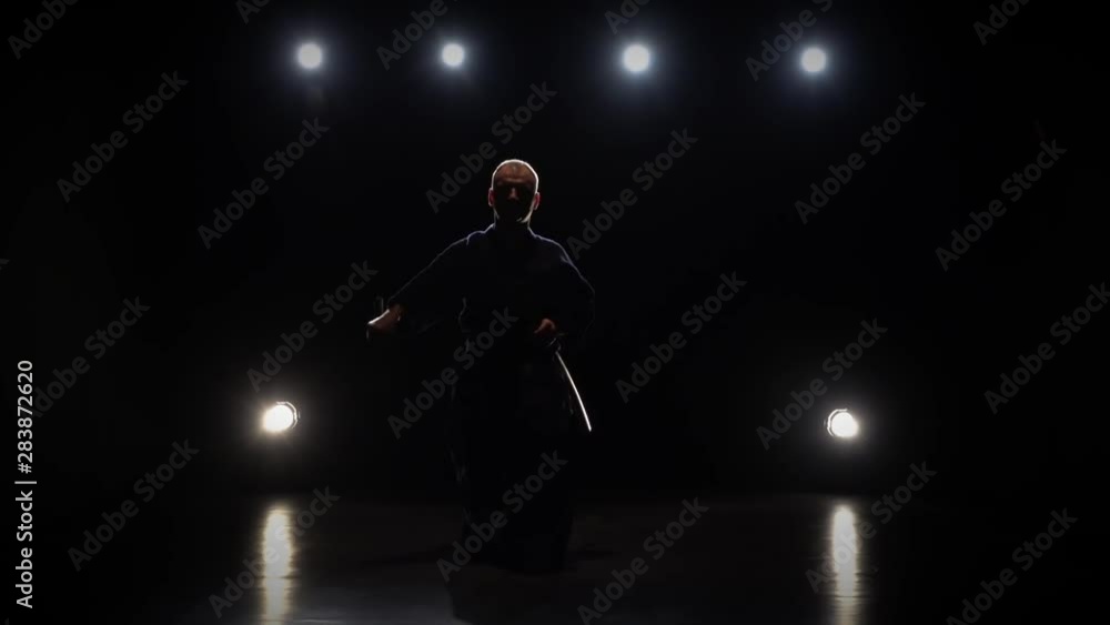 Kendo warrior practicing martial art with the Katana sword. Slow motion Kendo warrior practicing martial art with the Katana sword. Slow motion