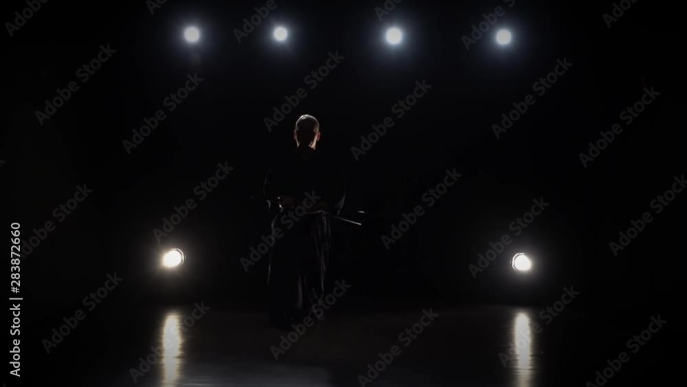 Kendo warrior practicing martial art with the Katana sword. Slow motion Kendo warrior practicing martial art with the Katana sword. Slow motion