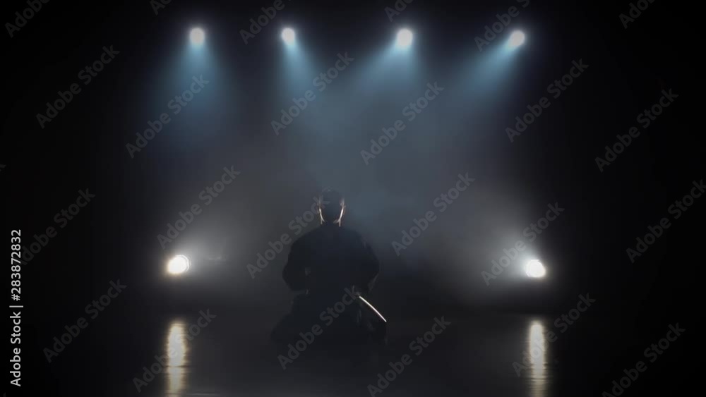 Kendo fighter practicing martial art with the Katana sword. Slow motion Kendo fighter practicing martial art with the Katana sword. Slow motion