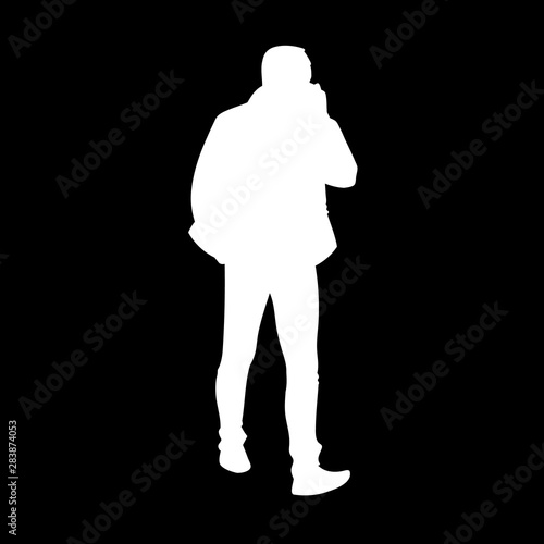 Adult man in jacket walking. White silhouette isolated on black background. Front view. Monochrome vector illustration of man taking a walk and talking on the phone. Concept.