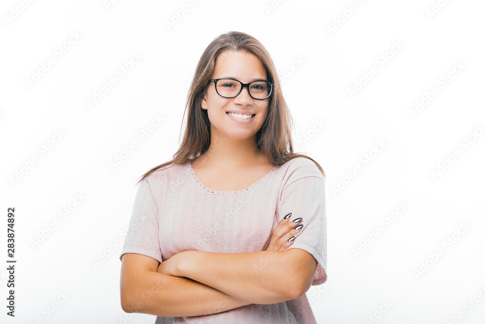 Photo of young woman wearing glasses, with folded hands and pretty smile, over isolated background Photo of young woman wearing glasses, with folded hands and pretty smile, over isolated background