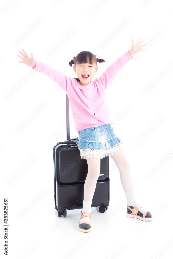 Little asian girl sitting on wheel suitcase and smiles over white background Little asian girl sitting on wheel suitcase and smiles over white background