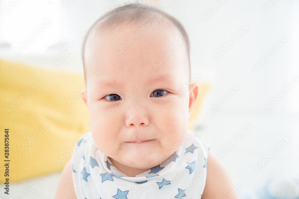 Closeup little asian baby crying and looking at camera Closeup little asian baby crying and looking at camera