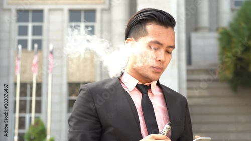 Asian business man vaping