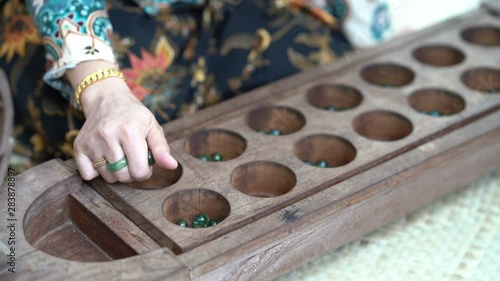 Woman playing congkak