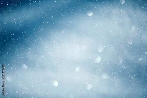  Blue shiny sky with realistic snowflakes. Happy Christmas and New Year copy space background. 