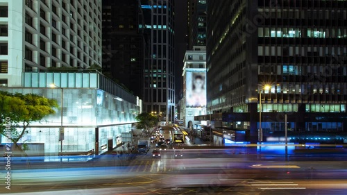 Very busy crossroads in the central district in rush hour. time lapse. Wide shot of intersection in the central district of big city photo