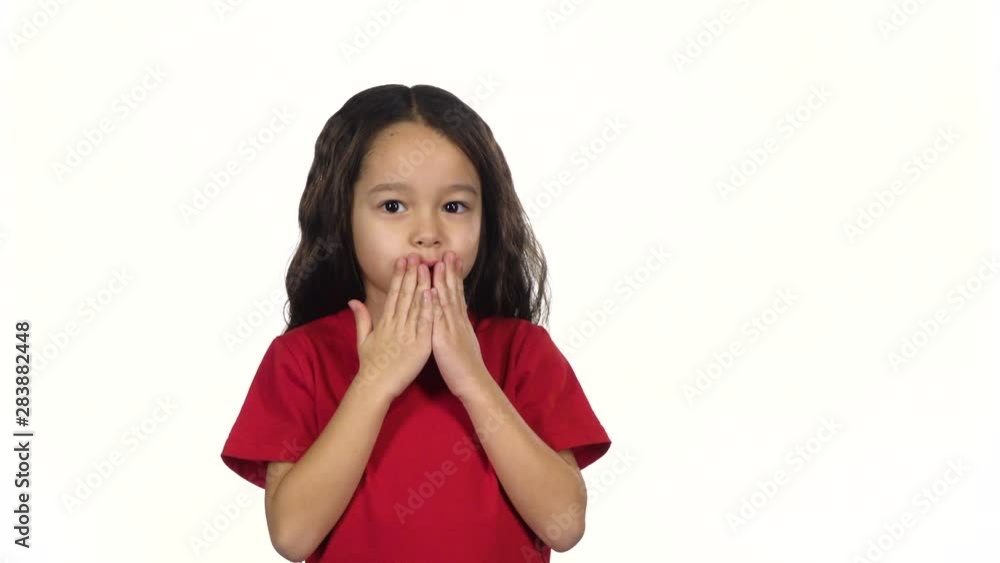 Brunette child making air kiss at white background. Slow motion Brunette child making air kiss at white background. Slow motion