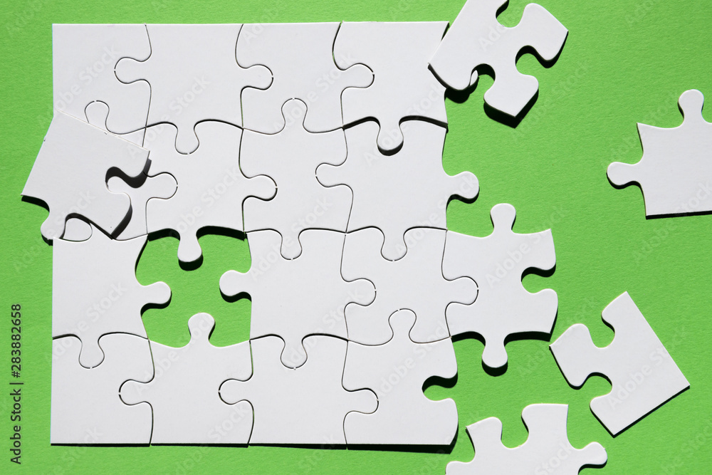 Close-up of puzzle piece on green background Close-up of puzzle piece on green background