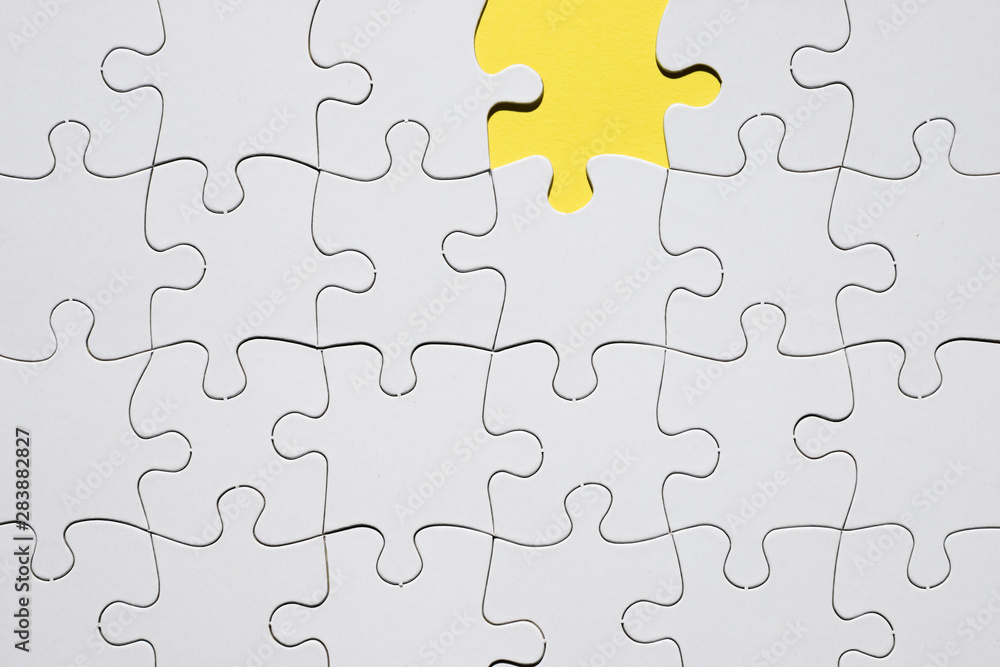 White jigsaw puzzle grid with missing puzzle piece White jigsaw puzzle grid with missing puzzle piece