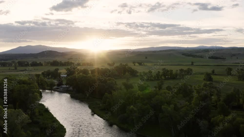 Aerial view of a beautiful sunrise over mountains along a snaking river. Shot above the North Platte River in Wyoming, USA | 4K Aerial view of a beautiful sunrise over mountains along a snaking river. Shot above the North Platte River in Wyoming, USA | 4K