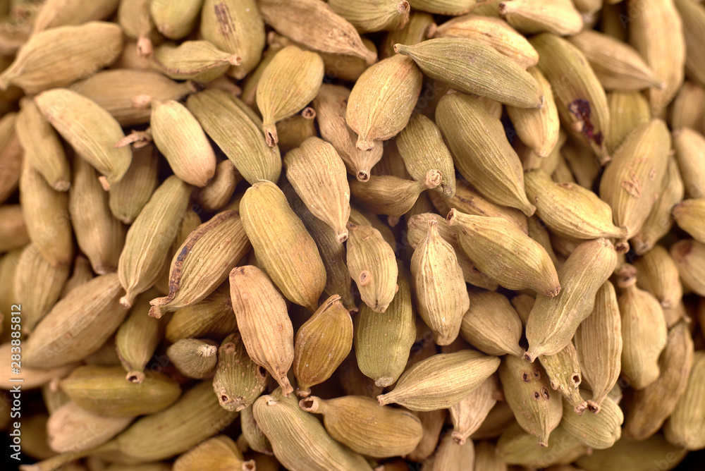 Pods of green cardamom background texture, copy space, close up. Top view, flat lay