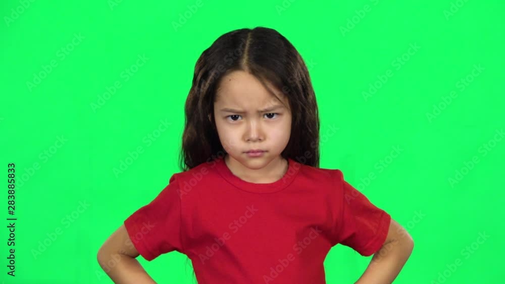 Little girl showing emotion punishment on green background. Slow motion Little girl showing emotion punishment on green background. Slow motion
